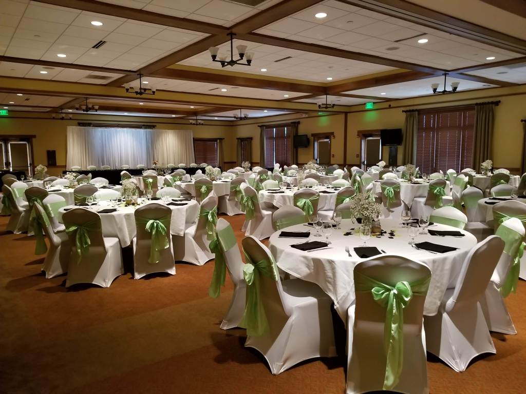 Light green decorated banquet tables for wedding reception dinner