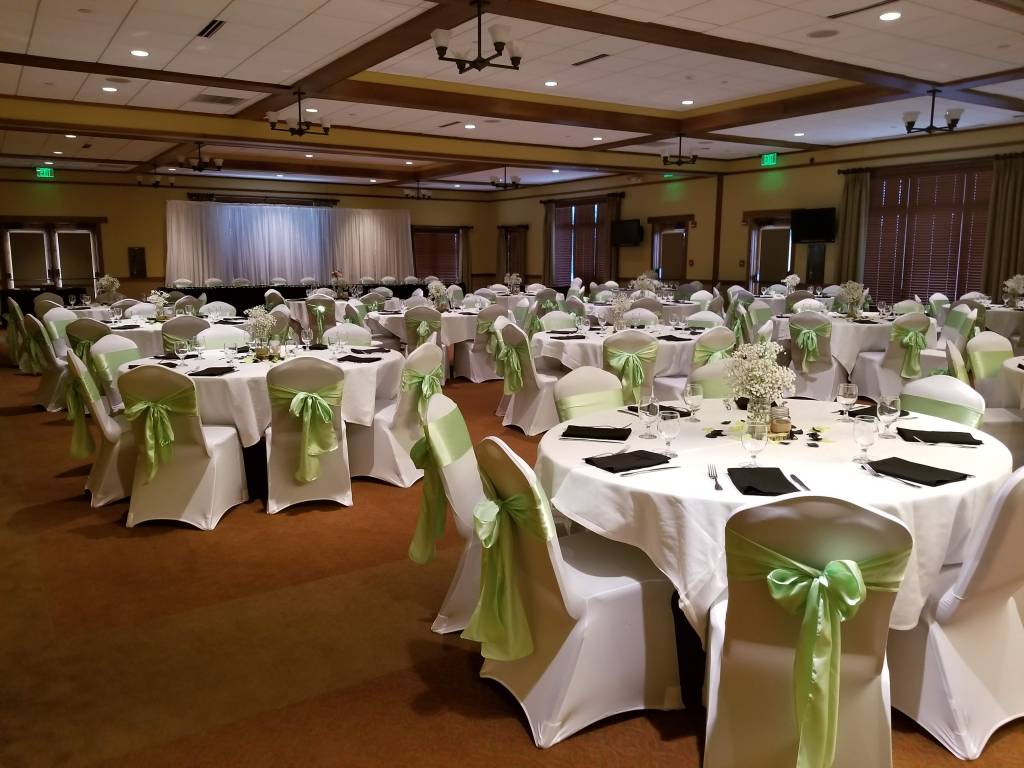 Wedding reception banquet dinner tables with light green decor