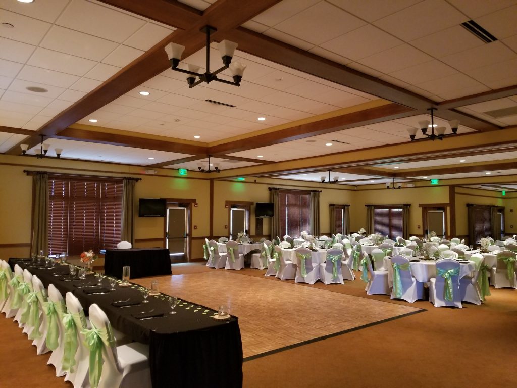 Reception banquet seating with white and green decorations