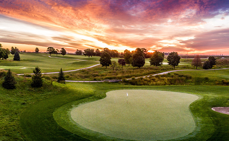 Golf course fairway at sunset